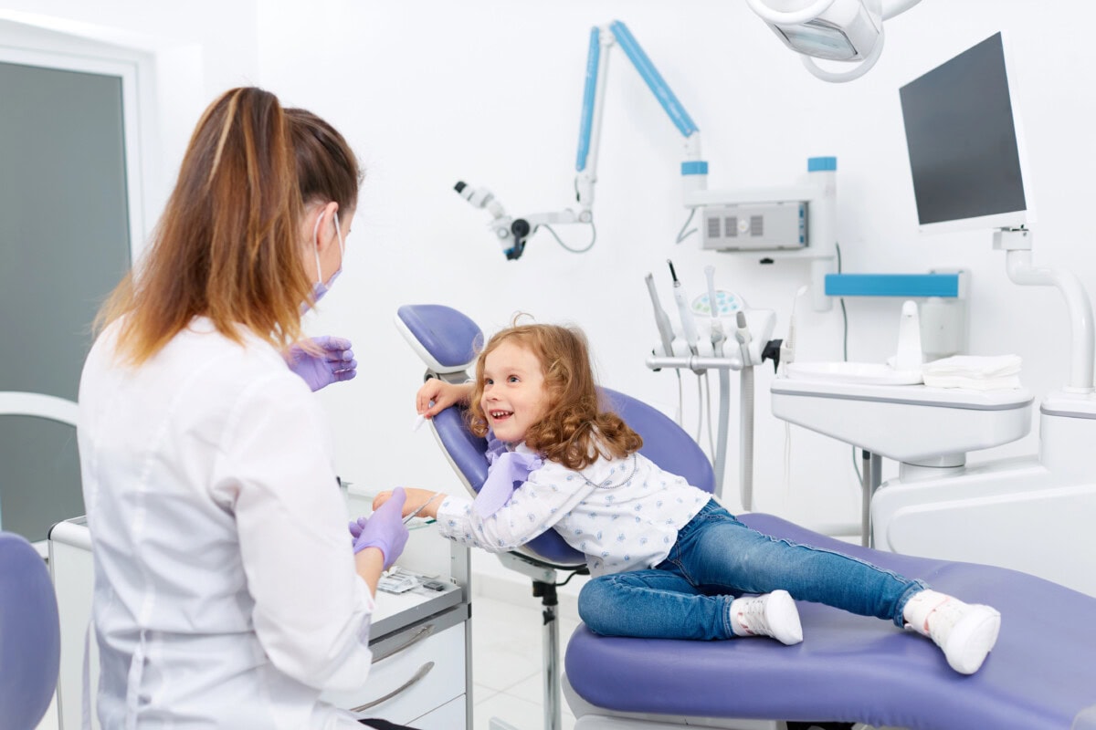 Little patient and dentist in cabinet