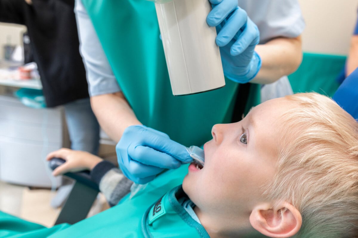 little boy at dentist s office doctor makes kid