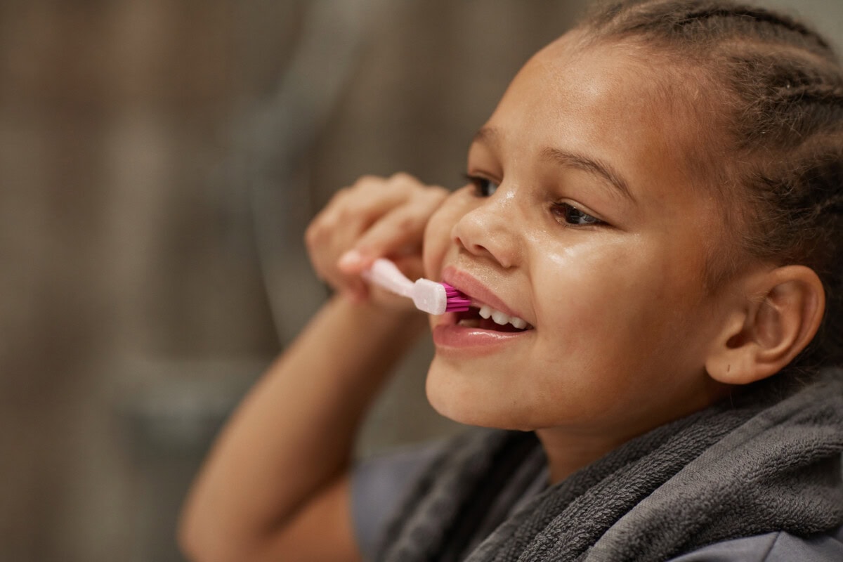 little girl brushing teeth